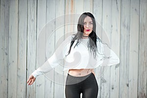 Portrait of a beautiful young woman in a white T-shirt with black hair. joy and laughter degenerate. positive emotions. Life style