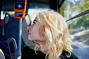 Portrait of a beautiful young woman who rides in a trolleybus