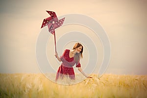 Portrait of beautiful young woman with wind toy on the wonderful