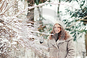 Portrait of beautiful young woman in wintertime in nature.
