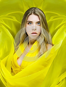 Portrait of a beautiful young woman in a yellow dress