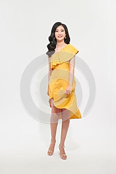 Portrait of a beautiful young woman in yellow dress and turn around