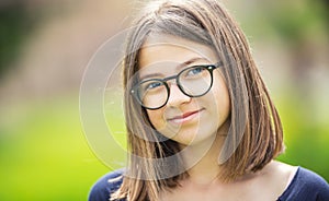 Portrait of a beautifull smilling teenage girl with glasses