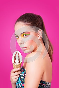 Portrait of beautifull woman with ice cream over pink background.