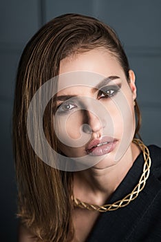 Portrait of the beauty. Beautiful, woman in a dress and jewelry, looking at the camera