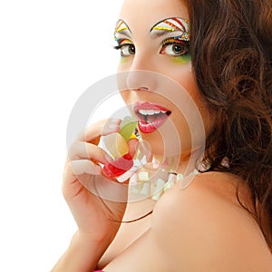 Portrait of beauty caucasian woman eating pink sweet candy