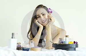 Portrait of beauty caucasian woman lying in spa salon with treatment spa set