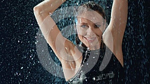 Portrait beauty feminine dance under drops of water rain in dark slow motion. 4k Dragon RED camera