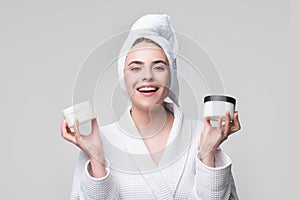 Portrait of beauty girl putting cosmetic cream on face. Female skin care concept. Proposing a cosmetics product