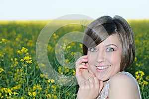 Portrait of the beauty girl on yellow meadow photo