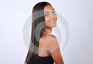 Portrait, beauty and Indian woman with hair care, texture and happiness against grey studio background. Face, female and