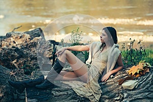 Portrait of beauty model girl with natural make up. Adult woman relaxed sitting on wood in park. Portrait beautiful