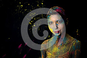 Portrait of beauty model with holi colorful powder art make on black background