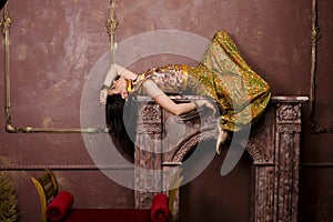 Portrait of beauty sensual young woman in oriental style in luxury room