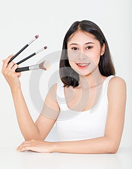 Portrait beauty studio shot of Asian short black hair female model with teeth retainer in tank top vest undershirt hold three size