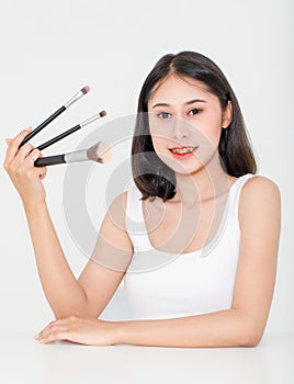 Portrait beauty studio shot of Asian short black hair female model with teeth retainer in tank top vest undershirt hold three size