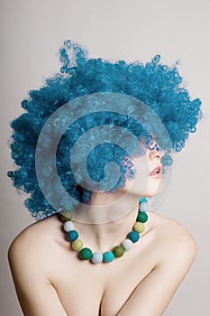 Portrait of beauty woman in a blue wig