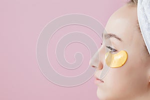 Portrait of Beauty Woman with Eye Patches on pink background. Woman Beauty Face with Mask under Eyes. Beautiful Female with