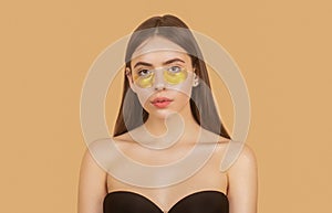 Portrait of beauty woman with eye patches showing an effect of perfect skin. Eyes mask cosmetic patches woman face