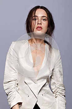 Portrait of beauty young brunette woman portrait in white fashion female jacket