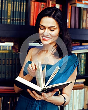 Portrait of beauty young brunette woman reading book in library smiling, muslim girl in education, lifestyle people