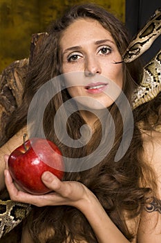 Portrait of beauty young lady with snake and red apple