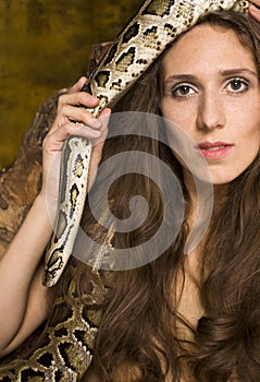 Portrait of beauty young lady with snake and red apple