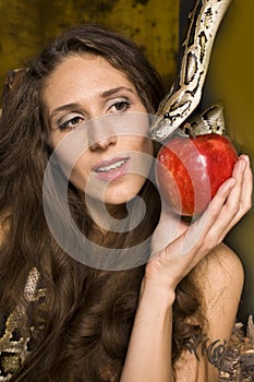Portrait of beauty young lady with snake and red apple
