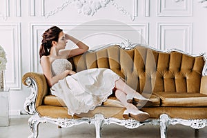 Portrait of beauty young sexy and attractive sensuality brunette woman in elegant dress sitting on sofa