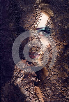 portrait of beauty young woman through lace close up mistery mak