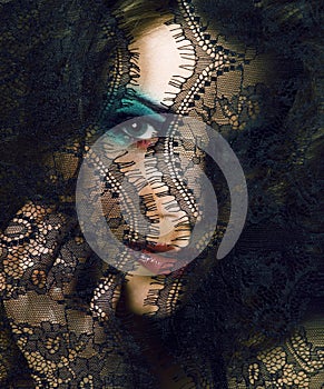 portrait of beauty young woman through lace close up mistery mak