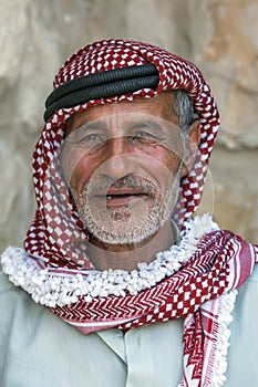 A portrait of a Bedouin man wearing traditional headware in Jordan.