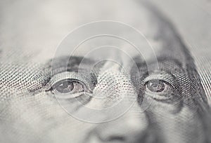 Portrait of Ben Franklin eye on the US 100 dollar bill in macro.