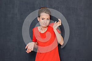 Portrait of bewildered girl raising hands and shrugging shoulders