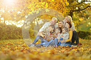 Big family having fun together in autumnal park