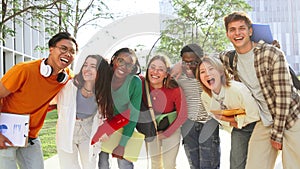 Portrait of a big group of smiling multiracial teenagers having fun outdoors. Cherful young people laughing together on