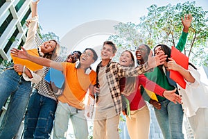 Portrait of a big group of smiling multiracial teenagers having fun outdoors. Cherful young people laughing together on photo