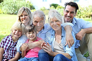 Portrait of big happy family sitting in grass