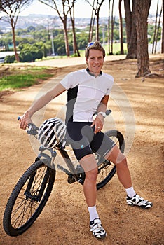 Portrait, bike and relax with man in nature for off road fitness, sports or outdoor cardio hobby. Cycling, forest and