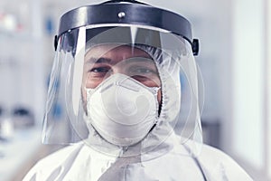 Portrait of biochemist in science laboratory wearing ppe protective equipment photo