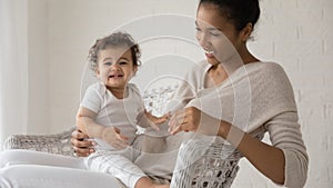 Portrait of biracial mom play with baby child