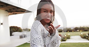 Portrait of biracial woman holding hand of partner, beckoning and smiling in garden in slow motion