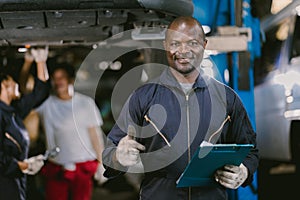 Portrait Black African mechanic garage worker check auto service team staff smart standing happy smile