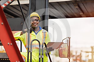 Portrait Black African staff worker happy smile working in cargo crane shipping logistic port