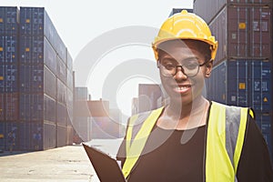 Portrait Black African woman engineer staff working in port cargo container yard for shipping import export industry