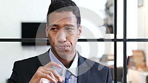 Portrait of Black Businessman Drinking Water