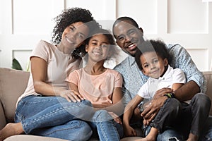 Portrait of black family with kids relax on couch