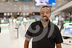 Portrait of black man ready to travel at airport terminal waiting for flight