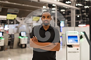 Portrait of black man ready to travel at airport terminal waiting for flight