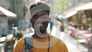 Portrait of black man smiling sincerely on city street